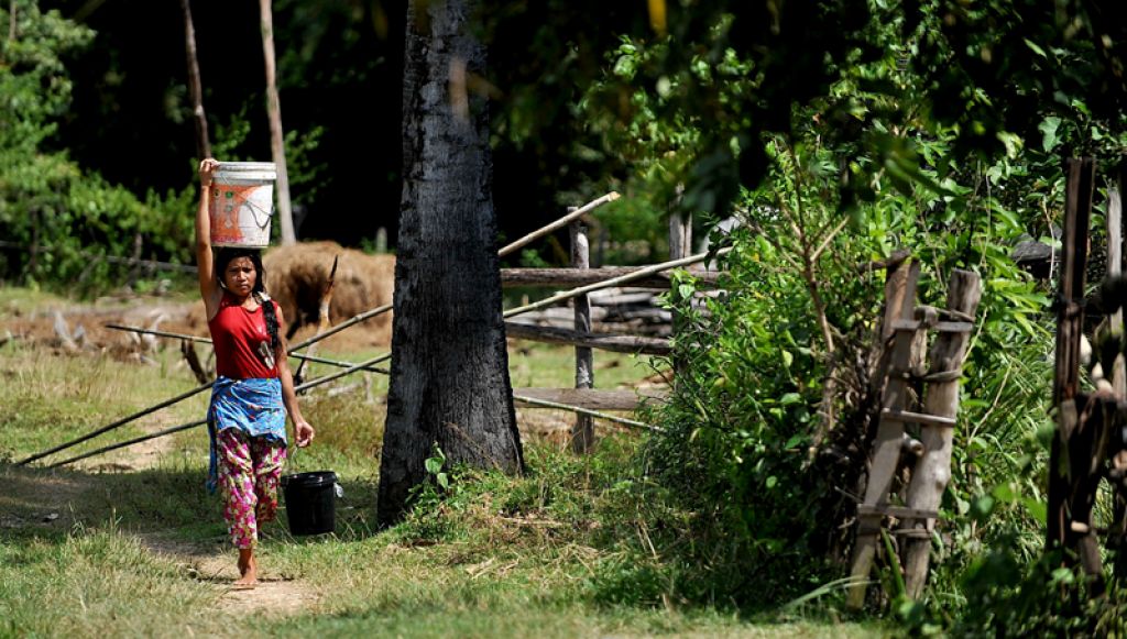 Cambodian woman collecting water. Photo: Eric Sales/ADB