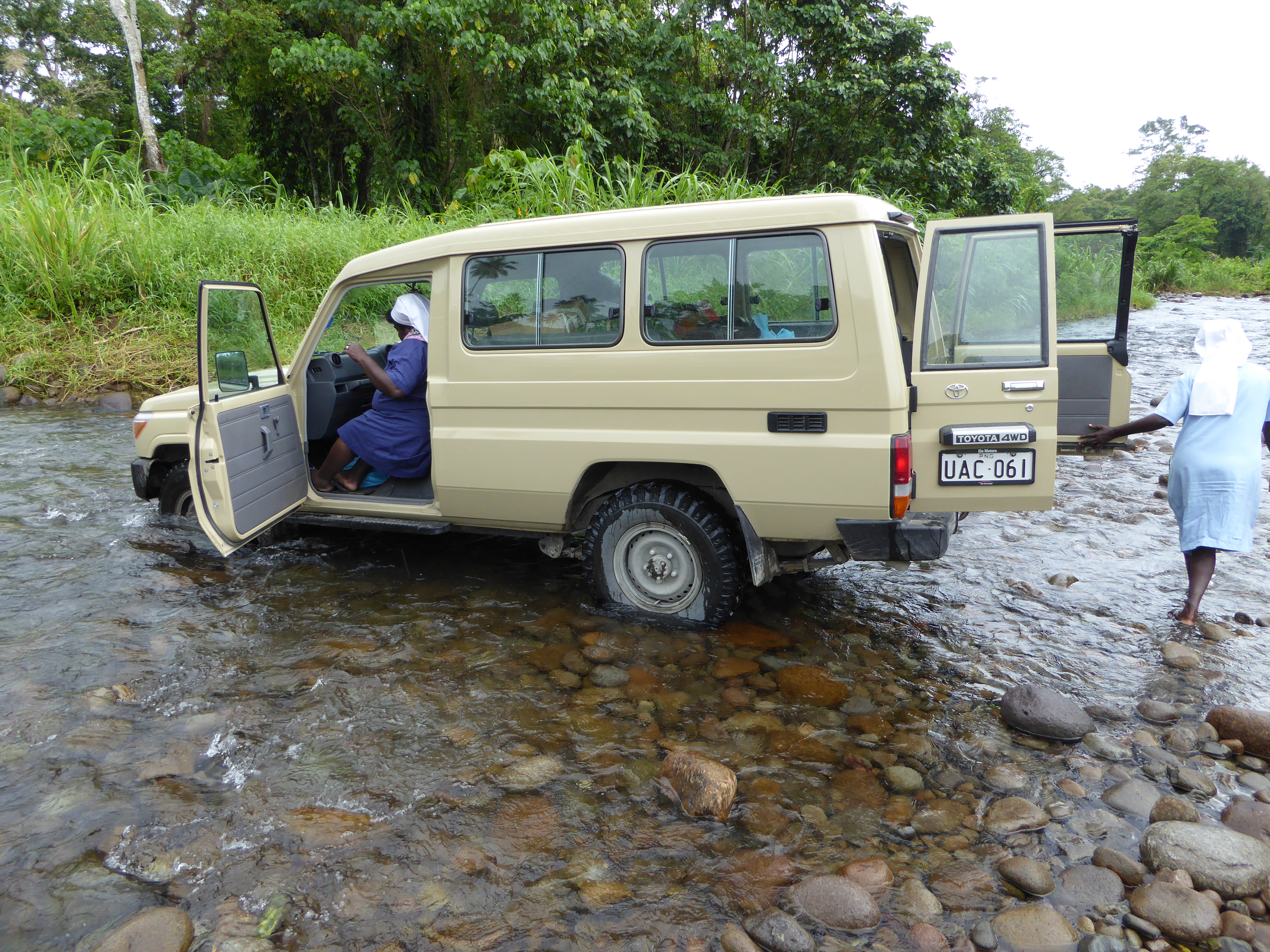 Women from Nazareth Rehabilitation Centre traversing a flooded road. Photo: Elena Leddra