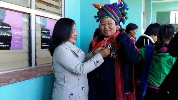 Mwe Noom, SWAN staff member distributing ribbons in Shan communities.