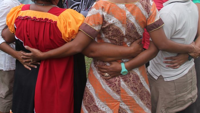 Pacific women linking arms