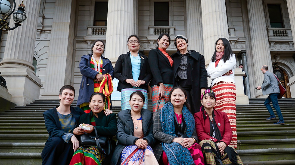 Image of women Myanmar MPs, IWDA staff and Emilys List founder standing outside Victoria's parliament building