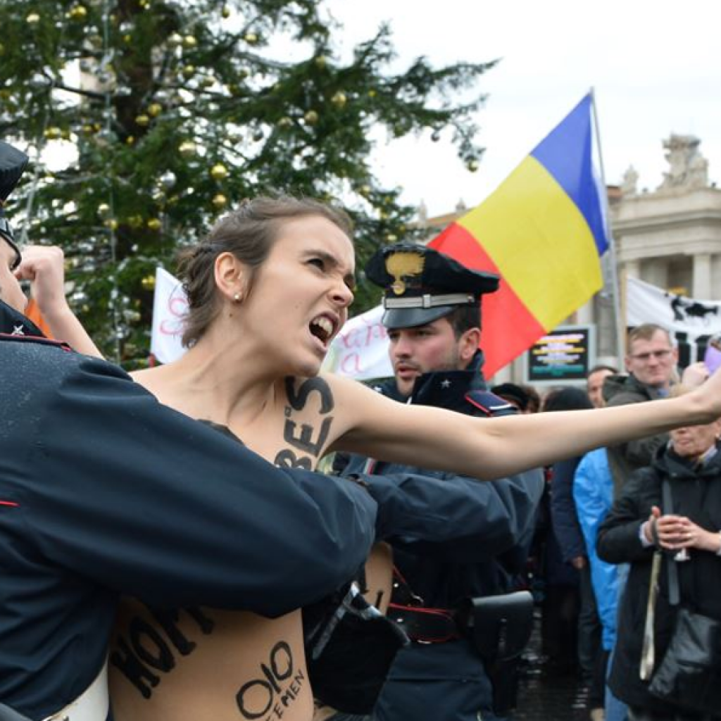 Police restrain a FEMEN activist outside The Vatican. Photo: AFP