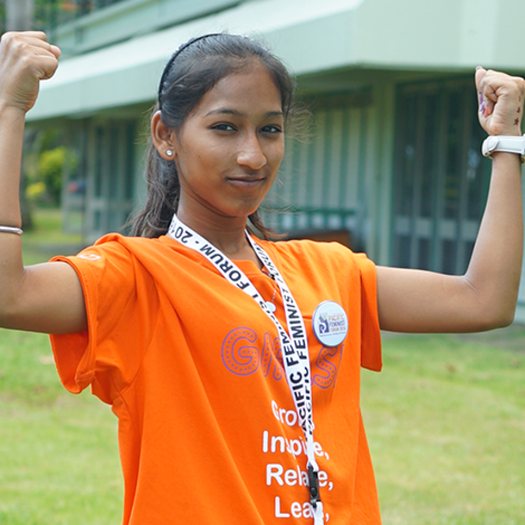 Image of girl in Fiji raising her arms