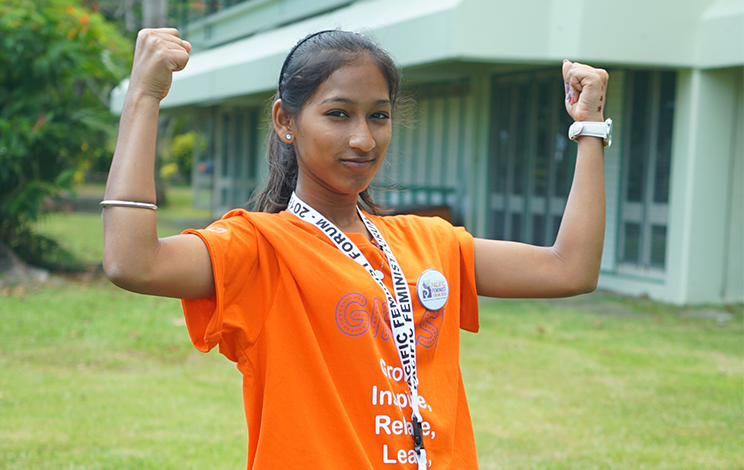 Image of girl in Fiji raising her arms