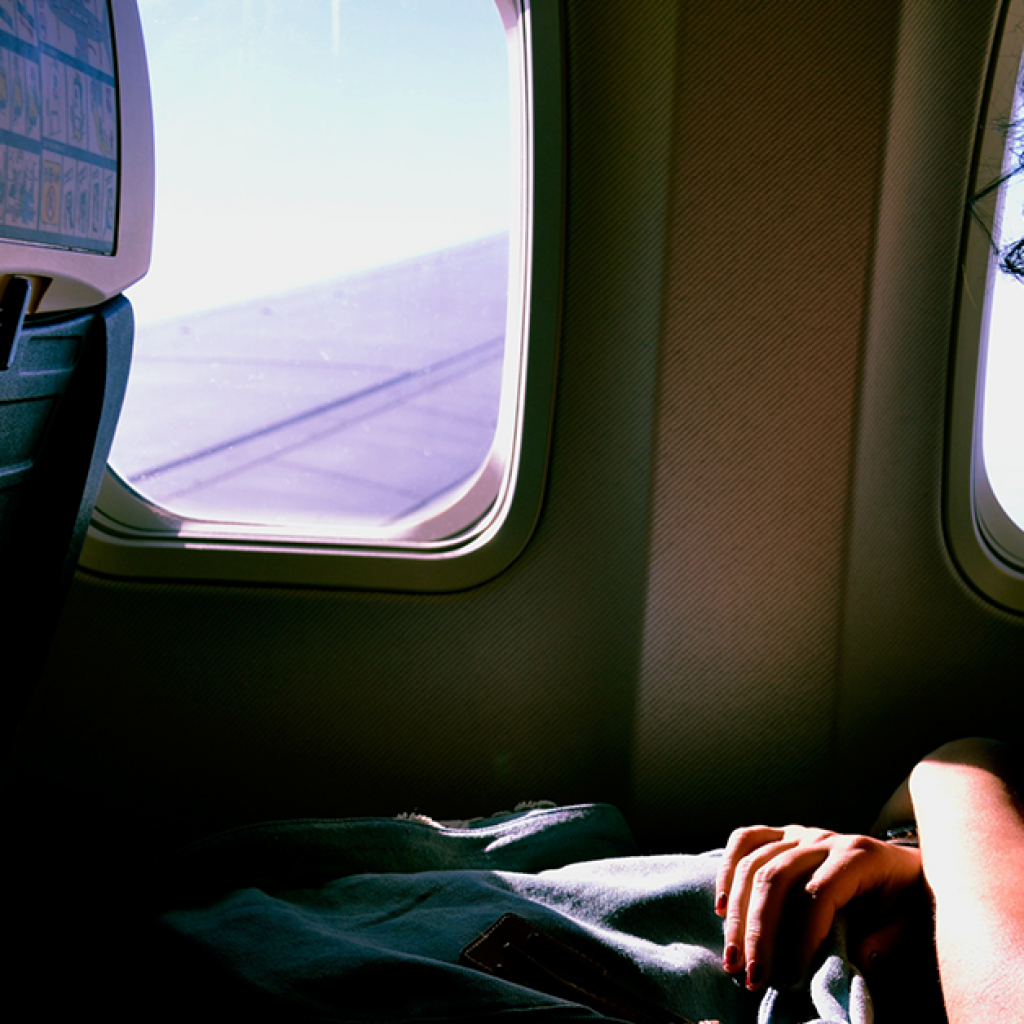 Woman on an airplane. Photo: Sofia Sforza/Unsplash