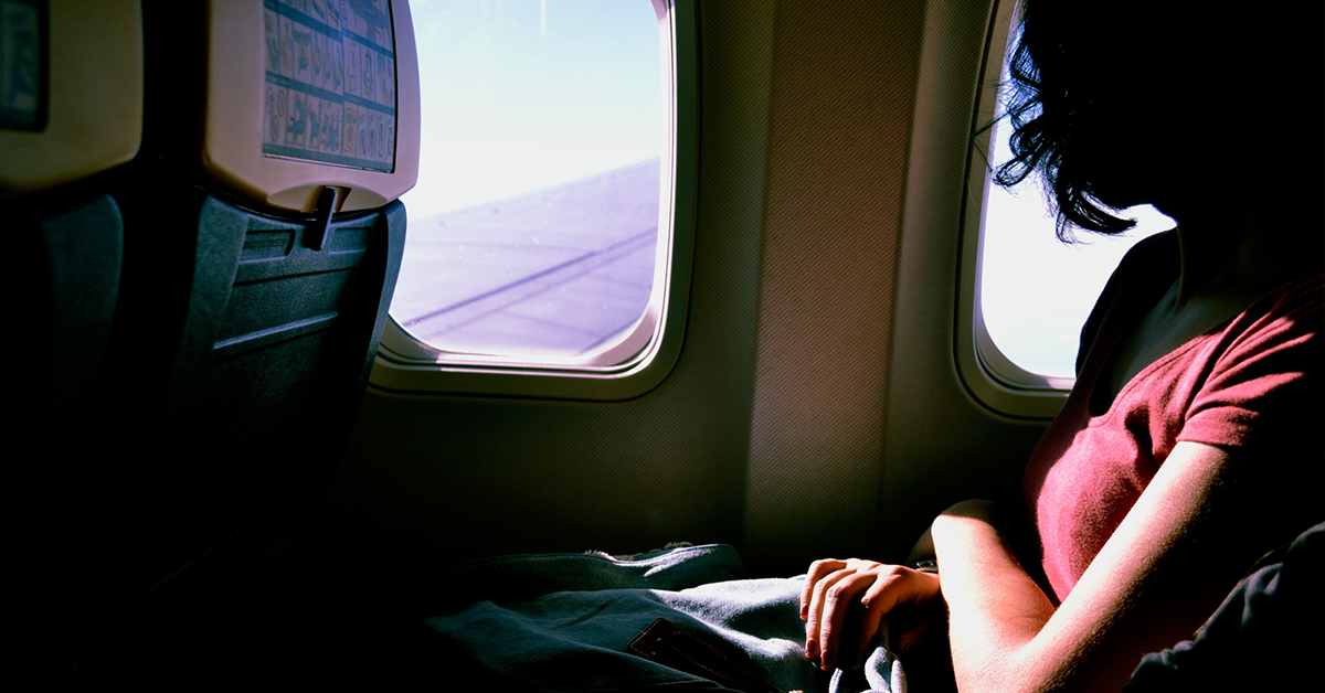 Woman on an airplane. Photo: Sofia Sforza/Unsplash