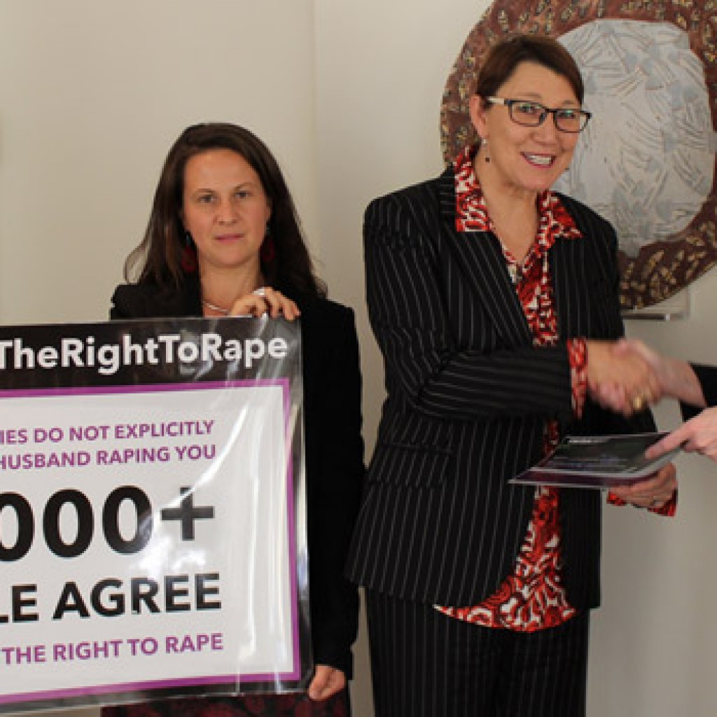 Joanna Hayter hands over the #EndTheRightToRape petition to Gillian Bird