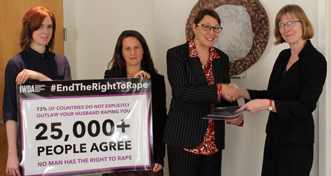 Joanna Hayter hands over the #EndTheRightToRape petition to Gillian Bird