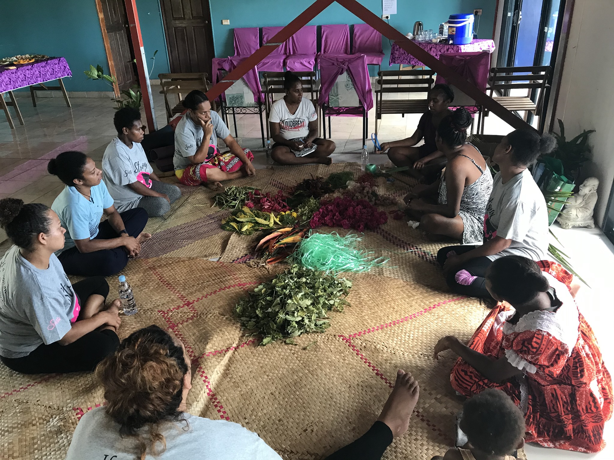 A group of women sit in a circle