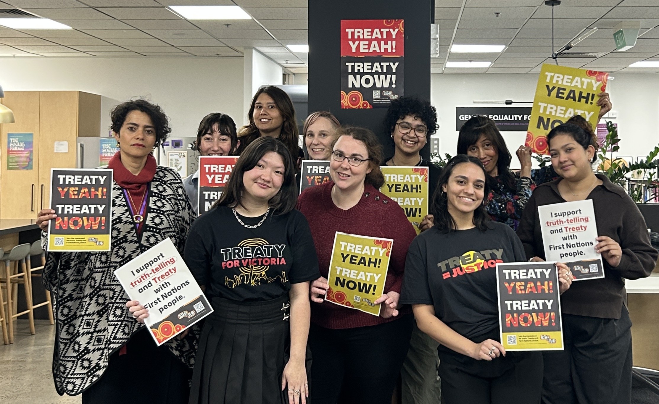 Photo of IWDA staff members holding together for treaty posters. 