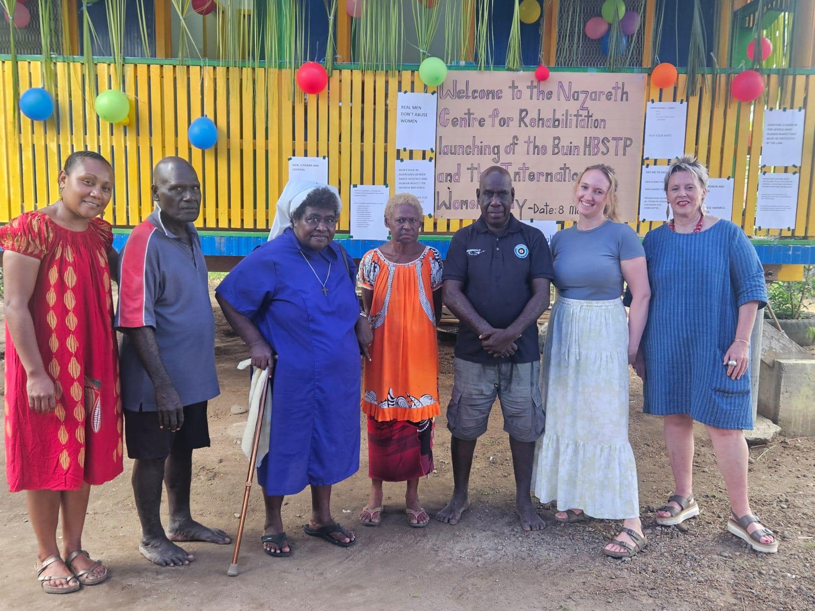 Staff from Nazareth Centre for Rehabilitation and IWDA post together in front of the newly opened Men's Hub.