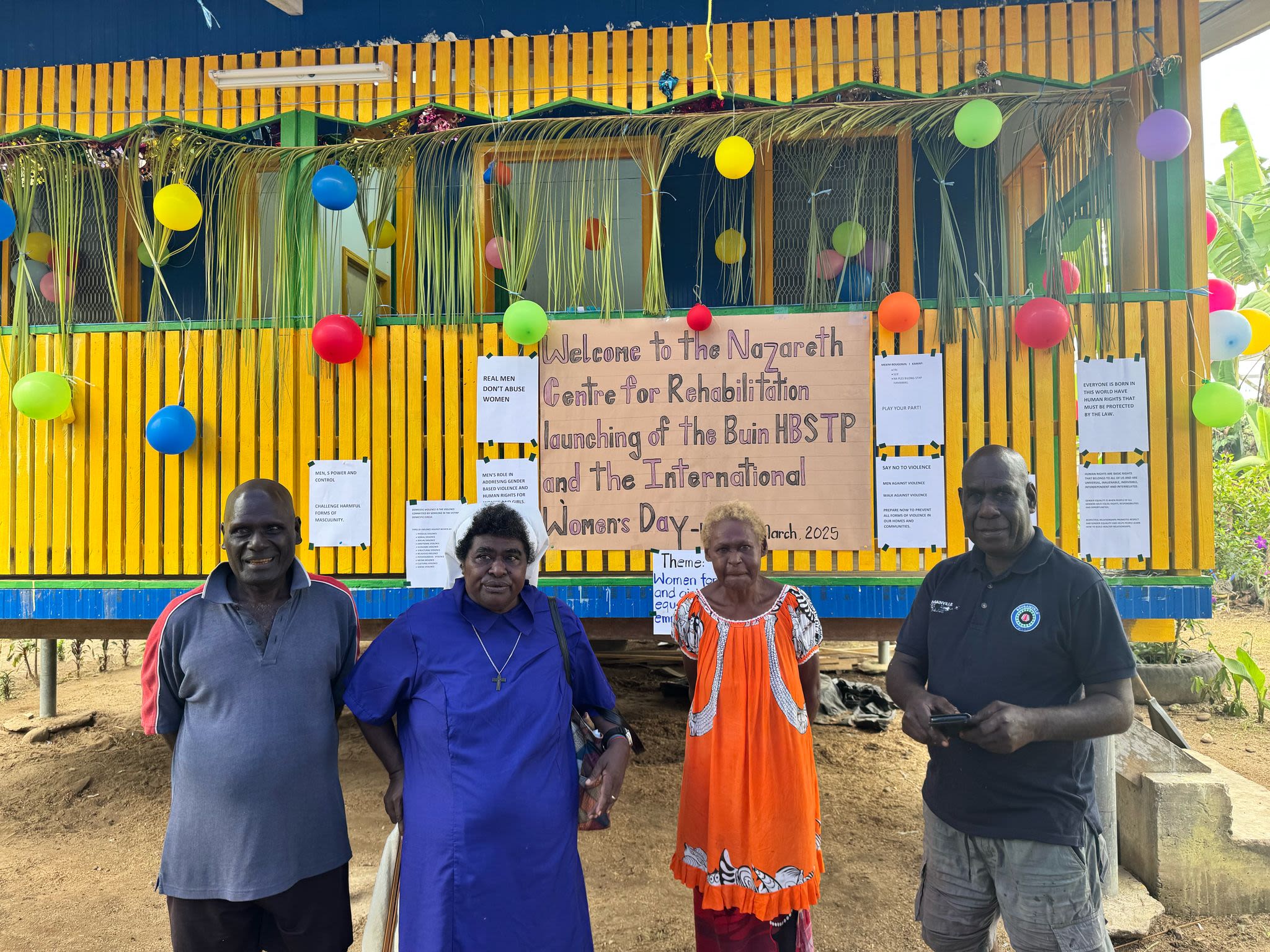 Staff from Nazareth Centre for Rehabilitation, including Men's Hub and Safe House counsellors, post together in front of the newly opened Men's Hub.