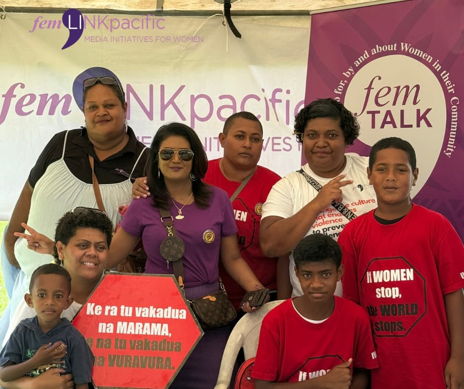 A group pose together for the camera at the femLINKpacific booth.
