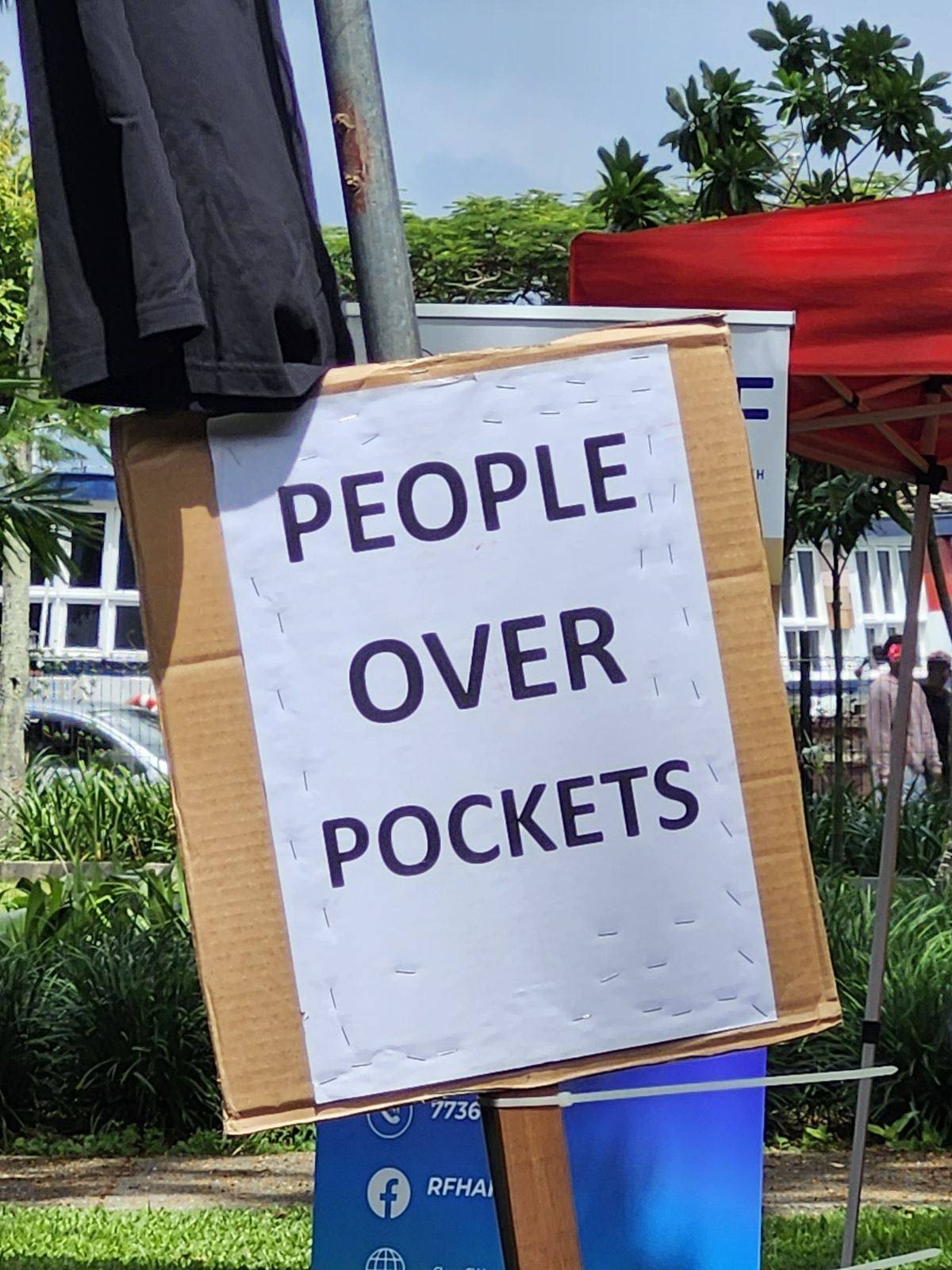 A sign at the concert that reads, 'People over pockets'. 