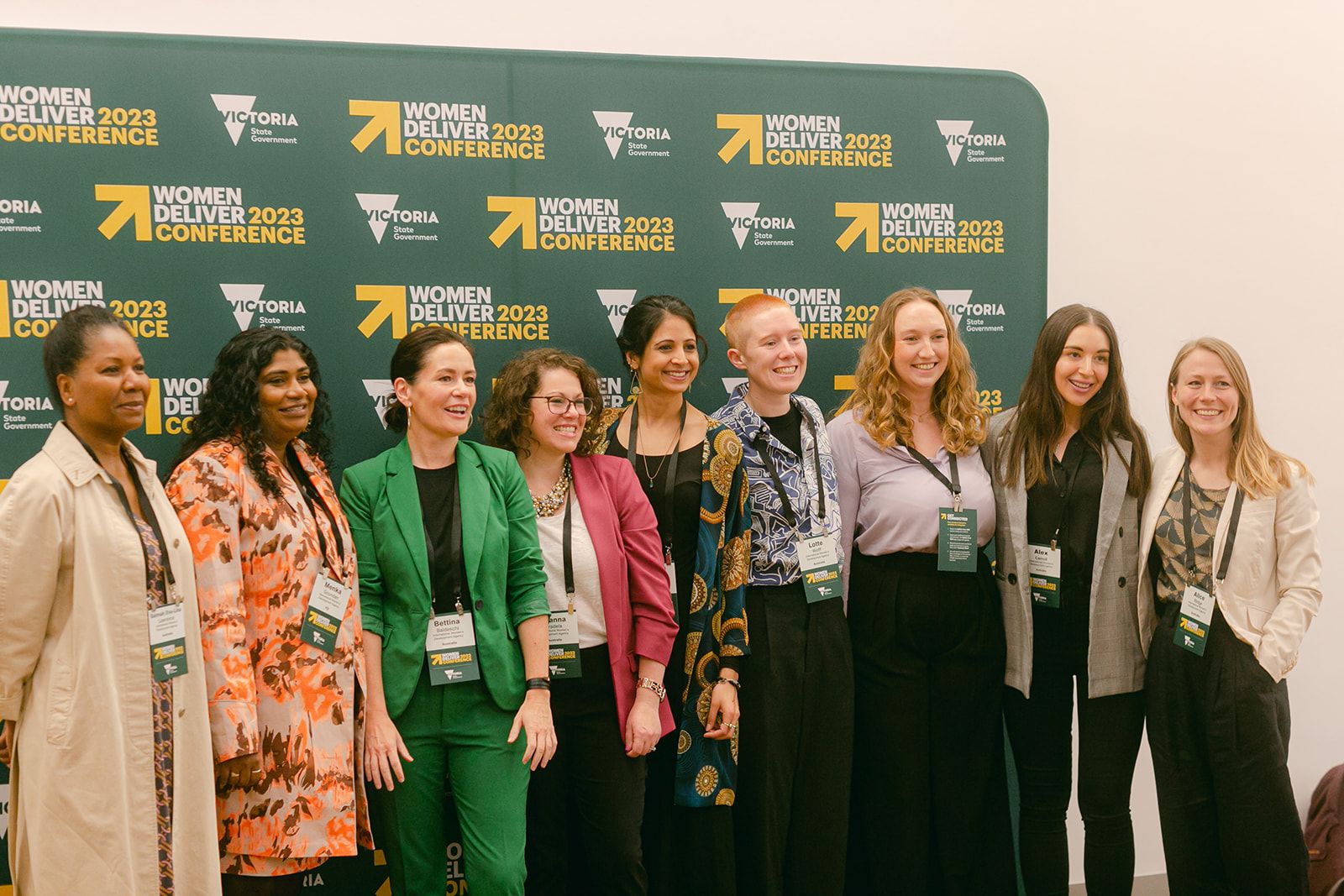 Bettina and IWDA staff at the Women Deliver 2023 conference in Melbourne. They are standing in front of a photowall with the WOmen Delivery 2023 Conference logo.