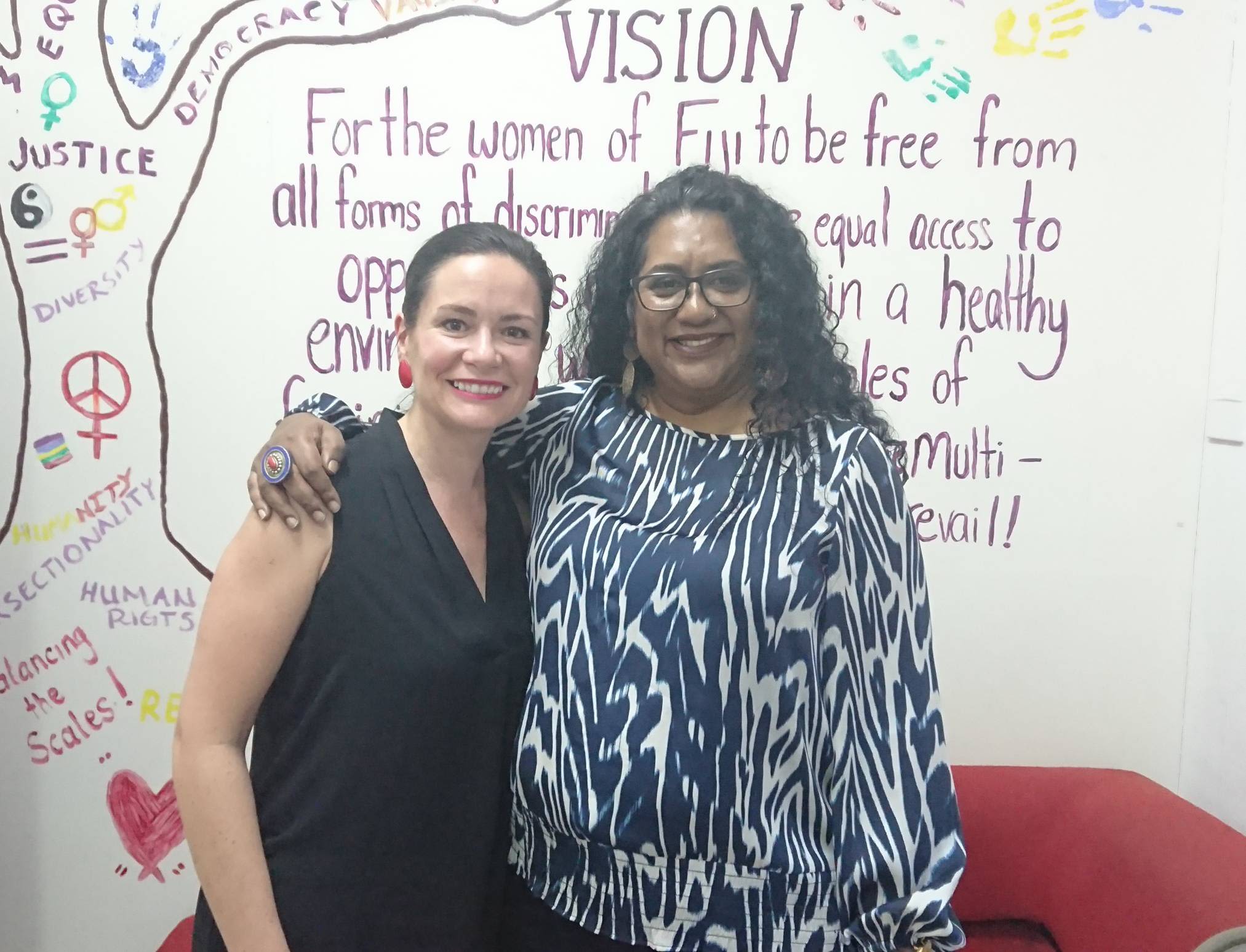Bettina and Nalini Singh (Executive Director of Fiji Women's Rights Movement) are posing together for the camera. They are smiling and have their arms around each other.