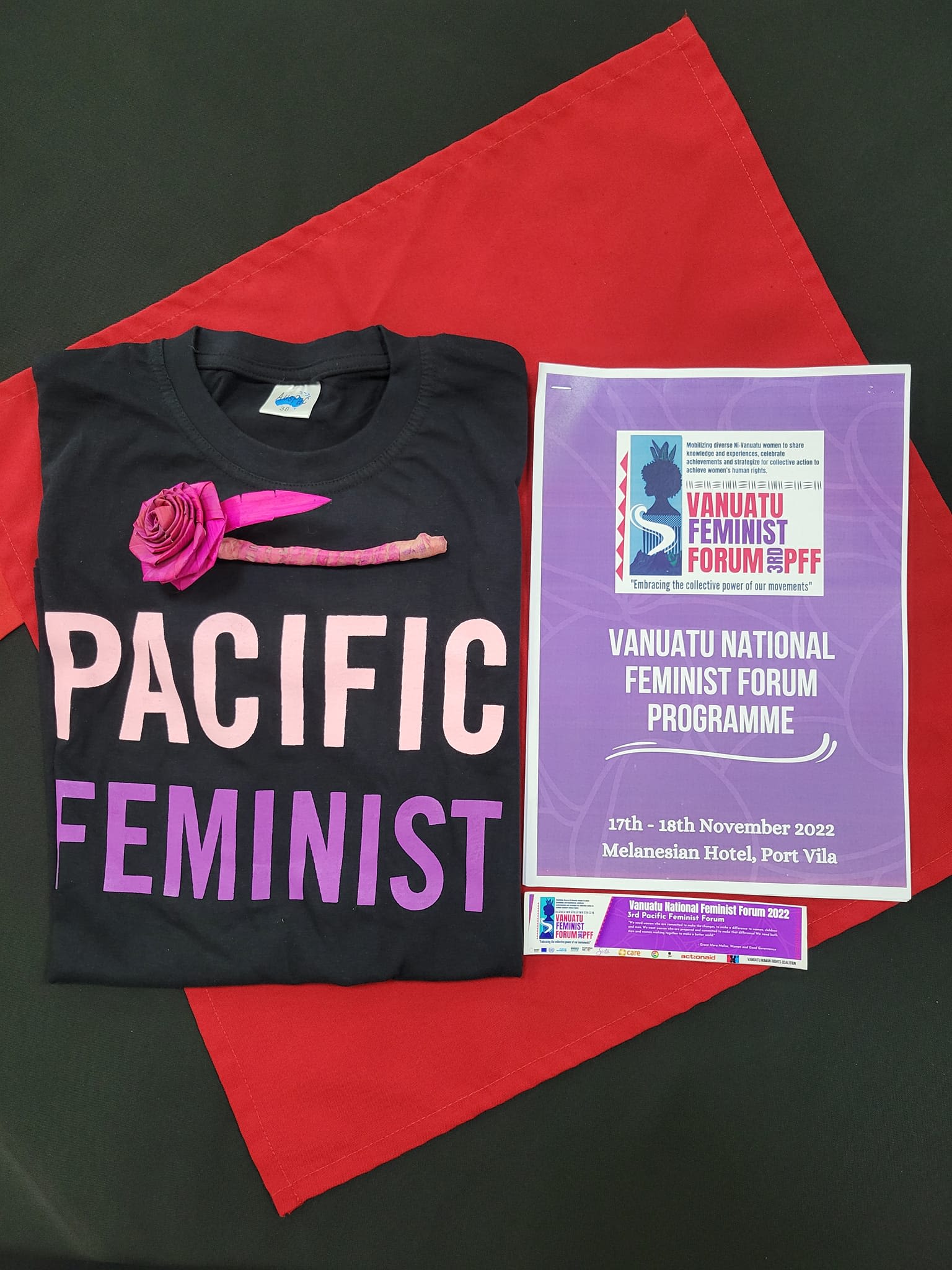 A shot of a table at the Vanuatu National Feminist Forum where a t-shirt with the words 'Pacific Feminist' and the forum programme are displayed.